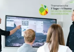 Mitarbeiter in einer Besprechungssituation vor einem Bildschirm