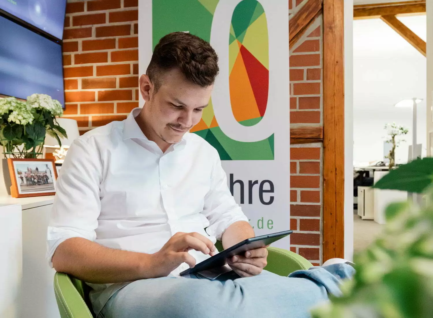 Konzeption Typo 3 Ein Mann sitzt am Tablet