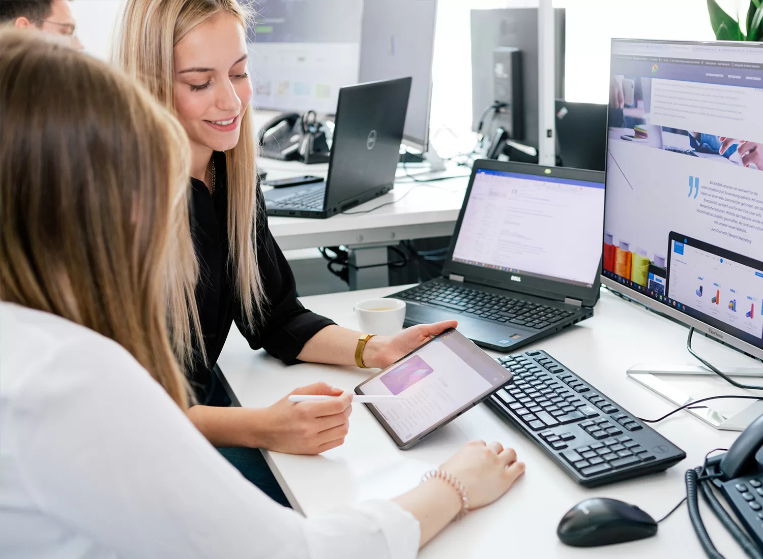 Gespräch zwischen Mitarbeitern Zwei Content-Marketing-Profis besprechen sich vor einem Computer